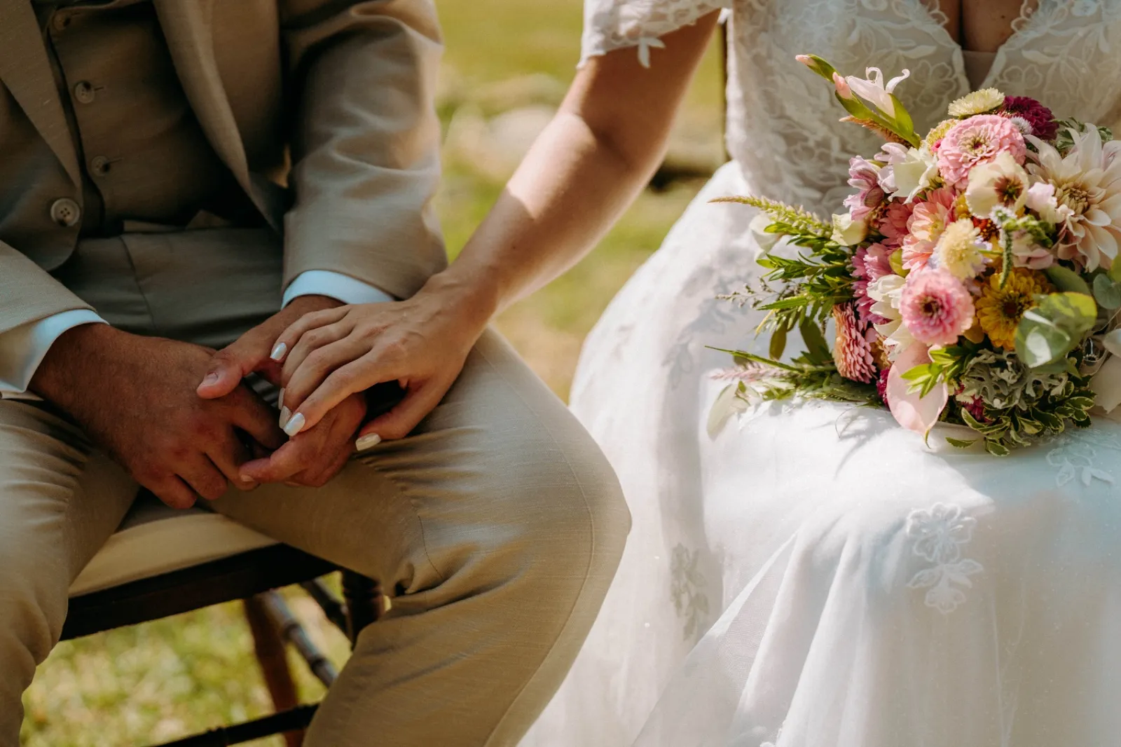 Bride and groom holding hands with the bridal bouquet at a destination wedding
